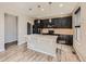 Modern kitchen with an island and dark cabinets at 10870 Unity Way, Commerce City, CO 80022