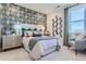 Serene bedroom with patterned wall, neutral bedding, and stylish accents at 14075 Deertrack Ln, Parker, CO 80134