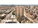 Stunning aerial view of high-rise building with downtown and mountain views in the distance at 550 E 12Th Ave # 209, Denver, CO 80203