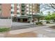 Building entrance with covered driveway, brick facade and garden landscaping at 550 E 12Th Ave # 209, Denver, CO 80203