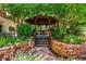 Wooden gazebo with stone pathway surrounded by lush greenery in a serene outdoor setting at 550 E 12Th Ave # 209, Denver, CO 80203