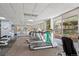 Bright gym with modern treadmills and equipment overlooking outdoor scenery at 550 E 12Th Ave # 209, Denver, CO 80203