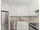 Modern kitchen with stainless steel appliances, ample storage, and stylish backsplash at 550 E 12Th Ave # 209, Denver, CO 80203