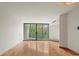 Spacious living area with hardwood floors, natural light, and sliding glass doors to a balcony at 550 E 12Th Ave # 209, Denver, CO 80203