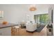 Inviting living room with hardwood floors, stylish lighting, and access to a private balcony at 550 E 12Th Ave # 209, Denver, CO 80203