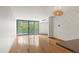 Bright living room features hardwood floors and large sliding doors to a balcony with a leafy view at 550 E 12Th Ave # 209, Denver, CO 80203