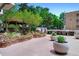 Community patio with outdoor grill, stone garden, and covered wooden gazebo at 550 E 12Th Ave # 209, Denver, CO 80203