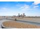 Spacious roof deck with scenic city views, stone accent, and landscaping at 550 E 12Th Ave # 209, Denver, CO 80203