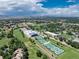 Aerial view showing the community, tennis courts, and golf course at 6100 W Mansfield Ave # 24, Denver, CO 80235