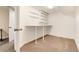 Finished basement with shelving and carpeted floor at 6100 W Mansfield Ave # 24, Denver, CO 80235