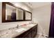 Double vanity bathroom with granite countertop and large mirror at 6100 W Mansfield Ave # 24, Denver, CO 80235