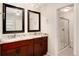 Elegant bathroom with double sinks, granite countertop, and a separate shower at 6100 W Mansfield Ave # 24, Denver, CO 80235