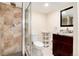 Basement bathroom with shower, toilet and vanity with granite countertop at 6100 W Mansfield Ave # 24, Denver, CO 80235