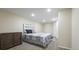 Basement bedroom with carpeted floor and a silver upholstered headboard at 6100 W Mansfield Ave # 24, Denver, CO 80235