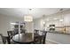 Dining area with dark wood table and chairs, open to kitchen at 6100 W Mansfield Ave # 24, Denver, CO 80235