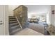 Bright entryway with stone accent wall and view of living room at 6100 W Mansfield Ave # 24, Denver, CO 80235