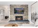 Living room boasts a stone fireplace and built-in seating at 6100 W Mansfield Ave # 24, Denver, CO 80235