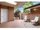 Private patio with brick walls and comfortable seating area at 6100 W Mansfield Ave # 24, Denver, CO 80235