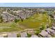 A beautiful aerial view of the neighborhood showcasing the homes, green space, and Denver skyline in the distance at 8487 S Nelson St, Littleton, CO 80127
