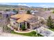 Wide aerial showcasing a two-story house with a three car garage and pristine landscaping at 8487 S Nelson St, Littleton, CO 80127