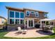 Backyard patio with outdoor seating, grill, and large windows at 8487 S Nelson St, Littleton, CO 80127
