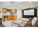 Finished basement with wet bar, projector screen, and comfortable seating area at 8487 S Nelson St, Littleton, CO 80127