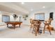 Finished basement with pool table, bar table, and carpeted floor at 8487 S Nelson St, Littleton, CO 80127