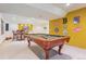Finished basement with pool table, bar table, and sports decor on the wall at 8487 S Nelson St, Littleton, CO 80127