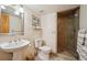 Modern bathroom featuring a pedestal sink, tiled shower, and neutral color scheme at 8487 S Nelson St, Littleton, CO 80127