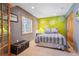 Comfortable bedroom featuring a striped bedspread, window, and decorative accent wall at 8487 S Nelson St, Littleton, CO 80127