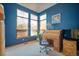 Bright bedroom featuring dark blue walls, tan carpet, and three large windows at 8487 S Nelson St, Littleton, CO 80127