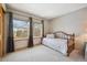 Bedroom featuring a large window, daybed, and neutral walls at 8487 S Nelson St, Littleton, CO 80127