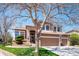 Charming two-story home featuring a three car garage, manicured lawn and brick accents at 8487 S Nelson St, Littleton, CO 80127