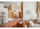 Bright foyer featuring hardwood floors, an open staircase, and a statement chandelier at 8487 S Nelson St, Littleton, CO 80127