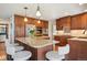 Spacious kitchen with an island, stainless steel appliances, and wood cabinetry at 8487 S Nelson St, Littleton, CO 80127