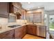 Galley kitchen featuring granite countertops, stainless steel appliances, and hardwood flooring at 8487 S Nelson St, Littleton, CO 80127