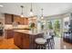 Open kitchen with an island, stainless steel appliances, and sliding doors to the backyard at 8487 S Nelson St, Littleton, CO 80127