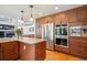 Kitchen featuring stainless steel appliances, granite countertops, and wooden cabinets at 8487 S Nelson St, Littleton, CO 80127