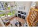 Vaulted living room featuring hardwood floors, fireplace, and large picture windows at 8487 S Nelson St, Littleton, CO 80127