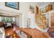 Bright living area featuring hardwood floors, a staircase, and dining room access at 8487 S Nelson St, Littleton, CO 80127