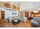 Open living room featuring a Juliet balcony, access to the kitchen, and hardwood floors at 8487 S Nelson St, Littleton, CO 80127