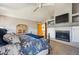 Spacious main bedroom includes fireplace, television and view of the staircase at 8487 S Nelson St, Littleton, CO 80127