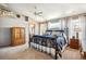 Bright main bedroom boasts ceiling fan, ensuite access, and sun-filled windows at 8487 S Nelson St, Littleton, CO 80127