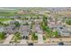 An aerial view of a neighborhood showcases well-maintained homes, green lawns, and mature trees in a planned community at 16226 W 94Th Dr, Arvada, CO 80007