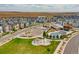 Aerial shot shows the community pool, park, landscaping, and parking for this beautiful community at 16226 W 94Th Dr, Arvada, CO 80007