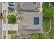 Aerial view showcases a home's roof with solar panels, driveway with parked cars, and detailed landscaping at 16226 W 94Th Dr, Arvada, CO 80007