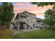 Beautiful backyard featuring a stone patio, built-in grill, and lush landscaping, ideal for entertaining guests at 16226 W 94Th Dr, Arvada, CO 80007