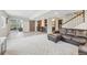 Open basement layout with a stylish bar area, sliding barn door, and cozy seating arrangement at 16226 W 94Th Dr, Arvada, CO 80007