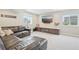 Spacious basement featuring a comfortable seating area, built-in media center, and ample natural light at 16226 W 94Th Dr, Arvada, CO 80007