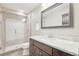Modern bathroom featuring a glass-enclosed shower, granite countertop vanity, and elegant fixtures at 16226 W 94Th Dr, Arvada, CO 80007